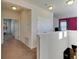 Upstairs hallway with carpet flooring and access to bedrooms at 10439 Waterstone Dr, Riverview, FL 33578