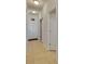 Clean and bright hallway with tile flooring and multiple doors at 10439 Waterstone Dr, Riverview, FL 33578