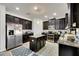 Spacious kitchen featuring dark wood cabinets, granite countertops, and stainless steel appliances at 10439 Waterstone Dr, Riverview, FL 33578