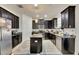 Dark wood kitchen cabinets, granite island, and stainless steel appliances at 10439 Waterstone Dr, Riverview, FL 33578