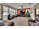 Living room featuring a fireplace, large TV, and a Christmas tree at 10439 Waterstone Dr, Riverview, FL 33578