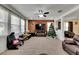 Spacious living area with fireplace, large TV, and view into the entryway at 10439 Waterstone Dr, Riverview, FL 33578