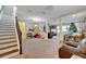 Open living space with carpeted floors, staircase, and a view into the Gathering room at 10439 Waterstone Dr, Riverview, FL 33578