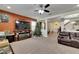 Open concept living room with a fireplace, large TV, and access to entryway at 10439 Waterstone Dr, Riverview, FL 33578