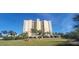 High-rise building with parking and lush landscaping at 10851 Mangrove Cay Ne Ln # 1112, St Petersburg, FL 33716