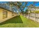 Spacious backyard with a large grassy area and wooden fence at 1116 N Riverhills Dr, Temple Terrace, FL 33617