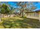 Large backyard with grassy area and wooden fence at 1116 N Riverhills Dr, Temple Terrace, FL 33617
