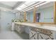 Elegant bathroom with dual sinks, large mirrors, and gold accents at 1116 N Riverhills Dr, Temple Terrace, FL 33617
