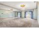 Primary bedroom with mirrored walls and a chandelier at 1116 N Riverhills Dr, Temple Terrace, FL 33617