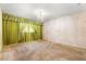 Large bedroom with chandelier, patterned wallpaper, and ample natural light at 1116 N Riverhills Dr, Temple Terrace, FL 33617