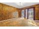 Bedroom with patterned wallpaper, chandelier and sliding glass doors at 1116 N Riverhills Dr, Temple Terrace, FL 33617