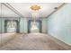 Large bedroom with mirrored walls, chandelier, and carpeting at 1116 N Riverhills Dr, Temple Terrace, FL 33617