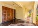 Double wood doors with detailed carvings and a long covered walkway at 1116 N Riverhills Dr, Temple Terrace, FL 33617