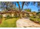 Home exterior showcasing landscaping and driveway at 1116 N Riverhills Dr, Temple Terrace, FL 33617