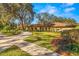 Ranch style home with mature landscaping and driveway at 1116 N Riverhills Dr, Temple Terrace, FL 33617