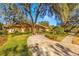 House with circular driveway and lush landscaping at 1116 N Riverhills Dr, Temple Terrace, FL 33617