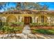 Spanish style home with a lush, manicured lawn and walkway at 1116 N Riverhills Dr, Temple Terrace, FL 33617