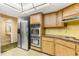 Kitchen boasts stainless steel appliances and wood cabinetry at 1116 N Riverhills Dr, Temple Terrace, FL 33617