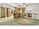 Kitchen with wood cabinets, a breakfast bar, and access to a sunroom at 1116 N Riverhills Dr, Temple Terrace, FL 33617