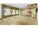 Bright living room with large windows, patterned wallpaper, and wood bar at 1116 N Riverhills Dr, Temple Terrace, FL 33617