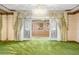 Living room with stained glass doors and a large crystal chandelier at 1116 N Riverhills Dr, Temple Terrace, FL 33617