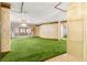 Living room with green shag carpet and patterned wallpaper at 1116 N Riverhills Dr, Temple Terrace, FL 33617