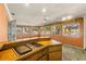 Sunroom with built-in bar and access to the kitchen and living room at 1116 N Riverhills Dr, Temple Terrace, FL 33617