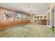 Bright sunroom with ample windows, ceiling fans, and access to other rooms at 1116 N Riverhills Dr, Temple Terrace, FL 33617