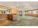Sunroom with wood-paneled wet bar, multiple windows and ceiling fans at 1116 N Riverhills Dr, Temple Terrace, FL 33617