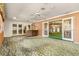 Sunroom with stained glass doors and access to a living area at 1116 N Riverhills Dr, Temple Terrace, FL 33617