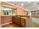 Built-in wet bar with wood cabinetry and a cooktop at 1116 N Riverhills Dr, Temple Terrace, FL 33617