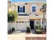 Tan two-story townhome with black door, garage, and landscaping at 1140 Andrew Aviles Cir, Tampa, FL 33619