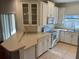 Kitchen boasts white cabinets and granite countertops at 1140 Andrew Aviles Cir, Tampa, FL 33619