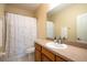 Bathroom with shower/tub combo, wood vanity, and a patterned shower curtain at 12303 Foxmoor Peak Dr, Riverview, FL 33579