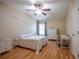Bright bedroom featuring a comfortable bed, wood floors, and a built-in desk at 12303 Foxmoor Peak Dr, Riverview, FL 33579