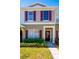 Two-story townhome with maroon shutters and a landscaped front yard at 12303 Foxmoor Peak Dr, Riverview, FL 33579