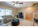 Living room with green couches, a TV, and access to the patio at 12303 Foxmoor Peak Dr, Riverview, FL 33579