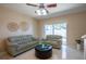 Living room with light green couches and a ceiling fan at 12303 Foxmoor Peak Dr, Riverview, FL 33579