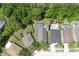 An aerial view showcases backyard pools, mature landscaping, and neighborhood homes in a lush, green setting at 14324 Moon Flower Dr, Tampa, FL 33626