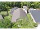 An aerial view showcases the backyard pool with enclosure, set among mature trees and green lawns at 14324 Moon Flower Dr, Tampa, FL 33626
