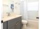 Updated bathroom features a gray vanity with solid surface counters, and a tub shower at 14324 Moon Flower Dr, Tampa, FL 33626