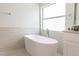 Modern bathroom with a stand alone tub, creating a spa-like atmosphere at 14324 Moon Flower Dr, Tampa, FL 33626