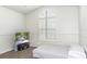 Arched window brings lots of light into this simple bedroom with a TV at 14324 Moon Flower Dr, Tampa, FL 33626