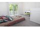 Colorful patterned bedspread and a sliding glass door makes this a cozy bedroom at 14324 Moon Flower Dr, Tampa, FL 33626
