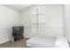 Bright bedroom featuring a unique arched window and shuttered blinds at 14324 Moon Flower Dr, Tampa, FL 33626