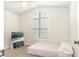 Well lit bedroom shows a large arched window and a television set for entertainment at 14324 Moon Flower Dr, Tampa, FL 33626