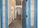 Welcoming foyer with blue front door, wood floors, and views of the open-concept layout at 14324 Moon Flower Dr, Tampa, FL 33626