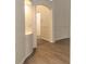 Hallway showcasing archways, neutral paint, and beautiful wood-look flooring, adding character at 14324 Moon Flower Dr, Tampa, FL 33626