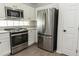 Well-equipped kitchen featuring stainless steel appliances, white cabinetry, and modern finishes at 14324 Moon Flower Dr, Tampa, FL 33626