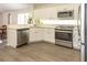 Updated kitchen with stainless steel appliances, white cabinets, and modern countertops at 14324 Moon Flower Dr, Tampa, FL 33626